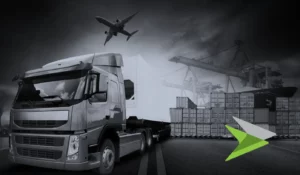 Truck with plane in sky above and seafreight containers being unloaded in background. In black and white.