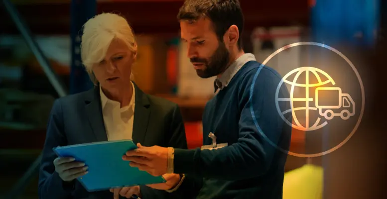 Two people looking at clipboard in warehouse