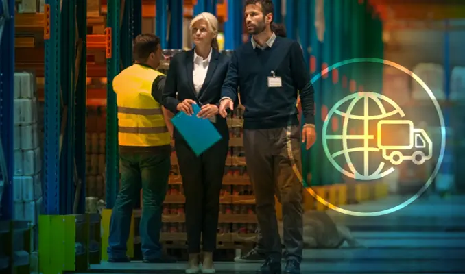 Two people walking through warehouse with clipboard