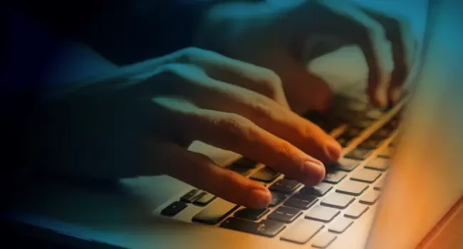 Hands typing on a keyboard