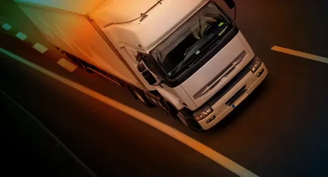 A truck at an angle on the road moving towards camera